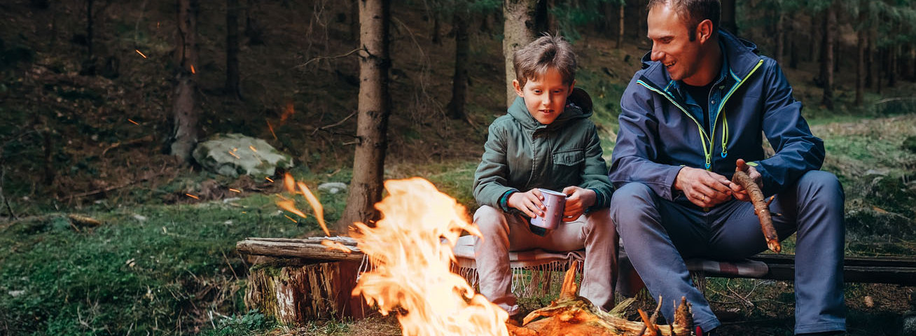 man and son sitting by the fire